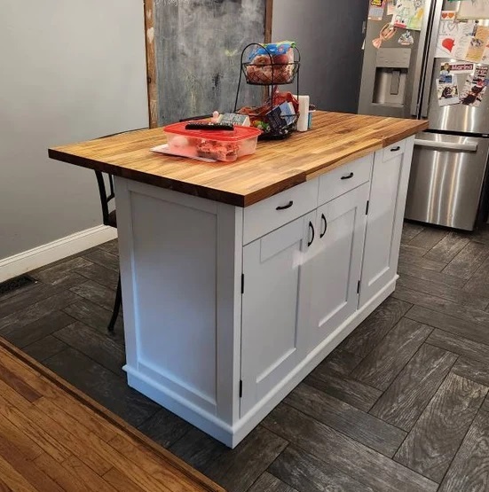 Custom Kitchen Island with drawers and storage cabinets. Butcher block with overhang for seating and trash area.